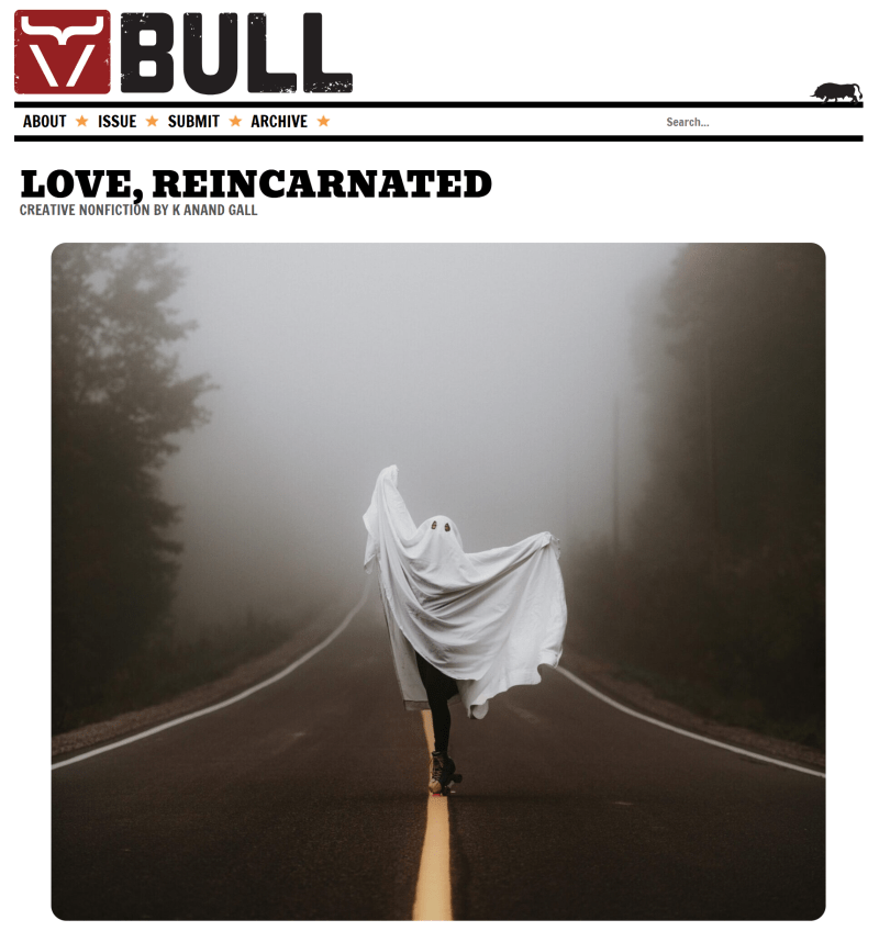 Website image with title of Love, Reincardnated with the BULL logo. The featured image shows a photograph of a person in a ghost costume skipping down a deserted highway with conifer trees and fog.